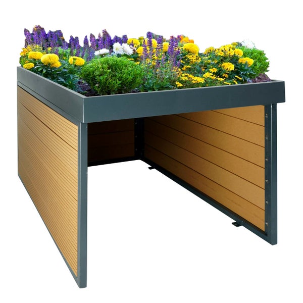 Mülltonnenbox mit Pflanzdach aus Metall und Paneelen in Holzoptik, bepflanzt mit gelben und violetten Blumen.
