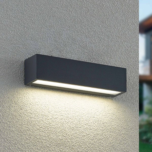 Moderne rechteckige Außenwandleuchte in Anthrazit mit Lichtaustritt nach unten an einer strukturierten Fassade.