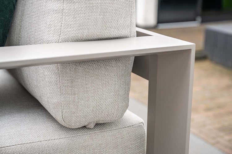 Nahaufnahme eines Gartenstuhls mit strukturiertem Stoffkissen und Metallrahmen.