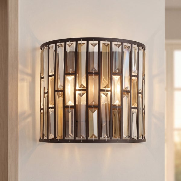 Moderne Wandleuchte mit rechteckigen Glaselementen in einem dunklen Metallrahmen, an einer Wand montiert und warm beleuchtet.
