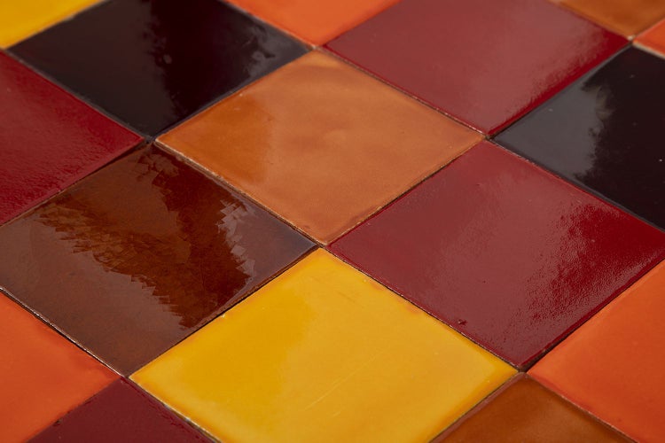 Nahaufnahme von quadratischen Keramikfliesen in verschiedenen Farben.