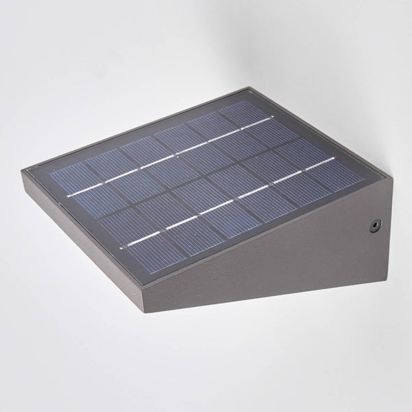 Graue Solar-Wandleuchte in Keilform mit integriertem Solarpanel auf der Oberseite.