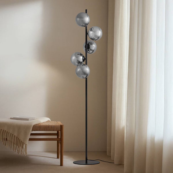 Stehleuchte mit fünf runden Leuchtenkörpern im Wohnzimmer.