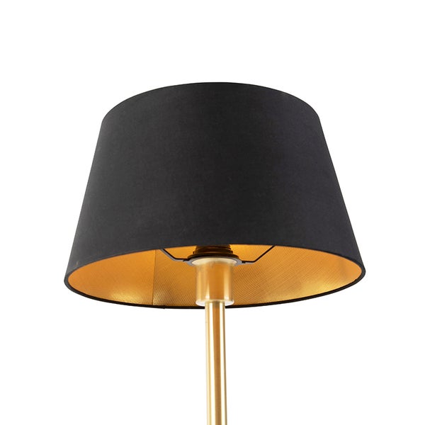 Lampenschirm mit schwarzem Textil außen und goldener Innenseite auf einem goldfarbenen Standfuß.