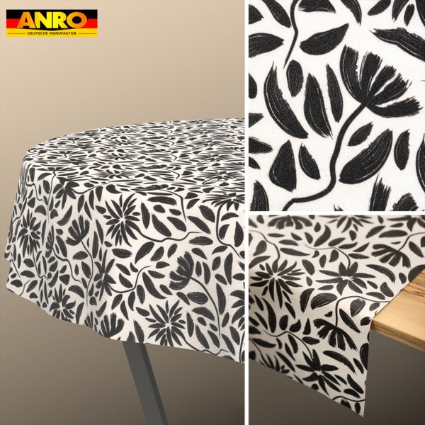 Runde Tischdecke mit schwarzem Blattmuster und Blumenmotiven im handgezeichneten Stil, ANRO Logo.