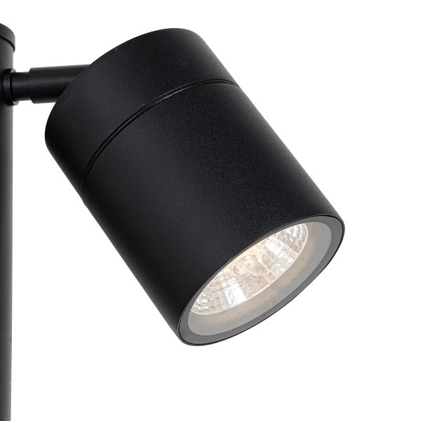 Zylindrischer Strahler aus schwarzem Metall mit strukturierter Reflektorlinse.