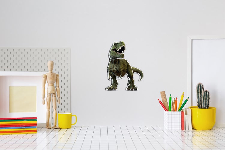 Wandtattoo Dinosaurier Tyrannosaurus Rex in einem hellen Raum über einem Schreibtisch mit Stiften und einem Kaktus.