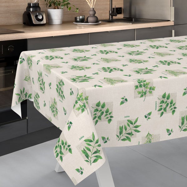 Abwaschbare Tischdecke mit Kräutermotiv wie Salbei und Calaminta auf einem Esstisch in einer modernen Küche.