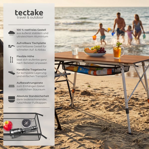 Klappbarer Campingtisch mit aufrollbarer Tischplatte in Holzoptik, Aluminiumgestell und Aufbewahrungsnetz am Strand. tectake Logo.