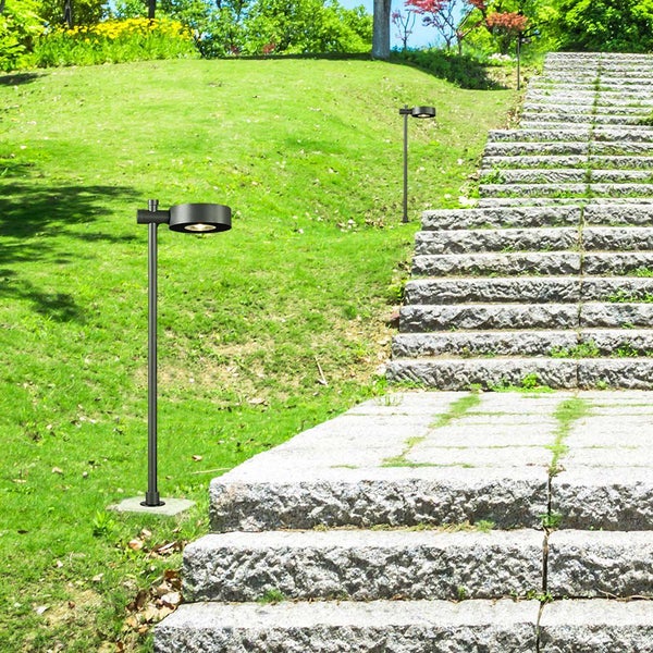 Gartenlandschaft mit Rasen und Treppe, beleuchtet durch eine Wegeleuchte