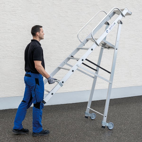 Mann schiebt eine fahrbare Arbeitsbühne aus Aluminium.