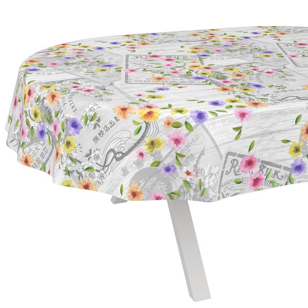 Abwaschbare Tischdecke mit buntem Blumenmuster und Vintage-Zeitungsdruck.
