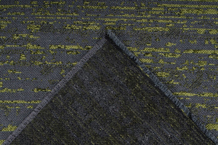 Gewebter Teppich mit abstraktem Muster, geketteltem Rand und umgeschlagener Ecke zur Ansicht der Rückseite.