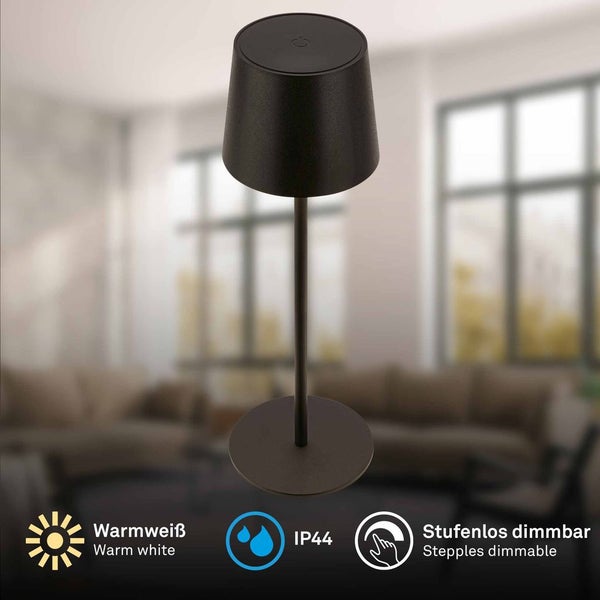 Schwarze kabellose LED-Tischleuchte mit warmweißem Licht und Touch-Dimmer, Schutzart IP44 gegen Spritzwasser, in einem hellen Wohnzimmer platziert.