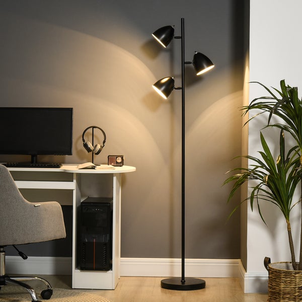 Stehleuchte mit drei Lampen neben einem Schreibtisch in einem Arbeitszimmer