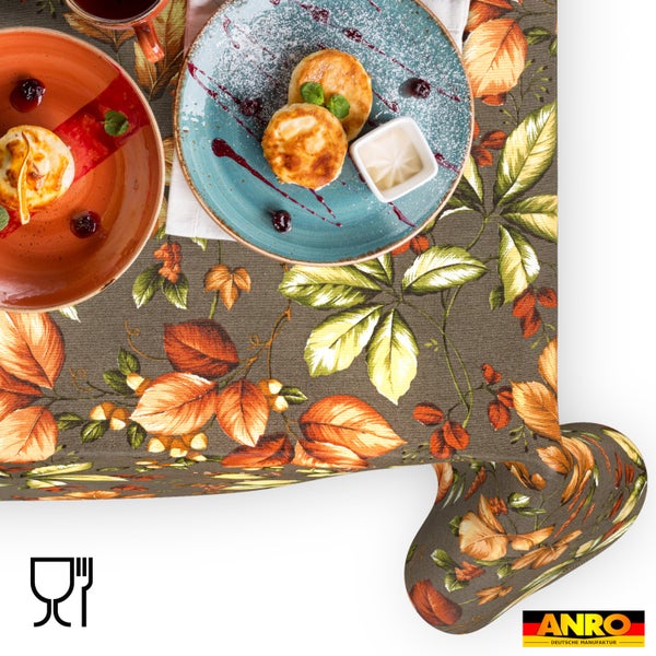 Tischdecke mit herbstlichem Blättermuster in Braun und Orange, Symbol für Lebensmittelechtheit und ANRO Deutsche Manufaktur Logo.