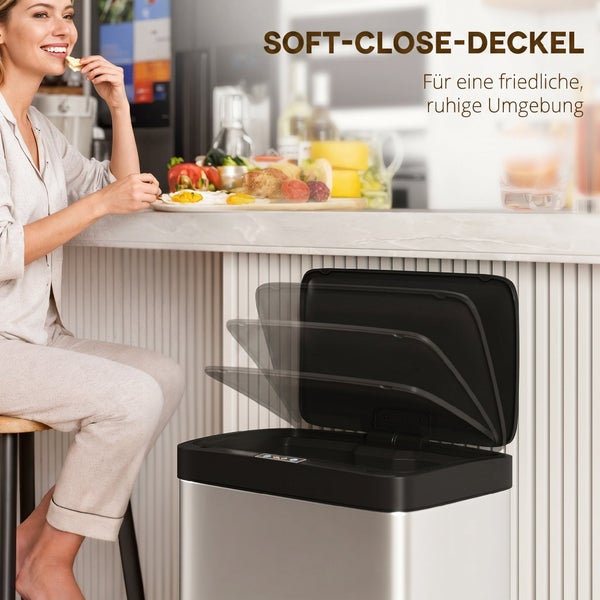 Ein Abfalleimer mit Soft Close Deckel in einer modernen Küche mit einer Frau beim Frühstück.