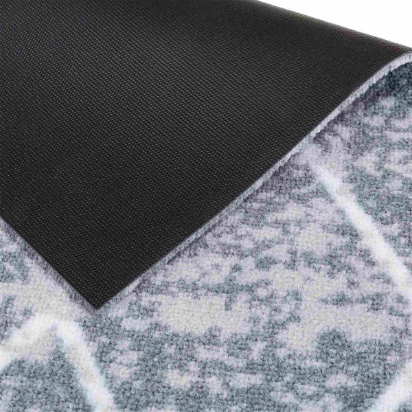 Detailansicht eines Teppichs mit Muster und rutschfester Rückseite.