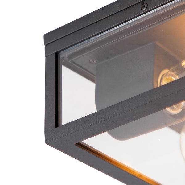 Nahaufnahme einer schwarzen, rechteckigen Deckenleuchte mit Metallrahmen und Glaseinsätzen.