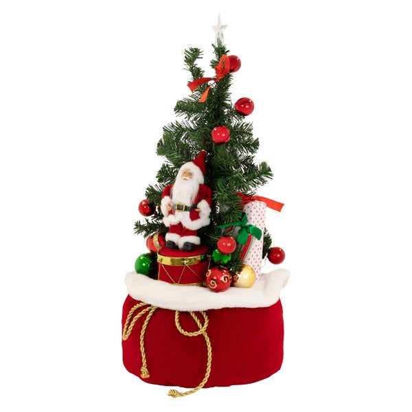 Weihnachtsdekoration mit kleinem Weihnachtsbaum, Weihnachtsmannfigur auf einer Trommel, Geschenken und rotem Geschenkesack.