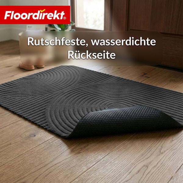 Schmutzfangmatte von Floordirekt mit konzentrischem Kreismuster und rutschfester wasserdichter Rückseite auf Holzboden. Floordirekt Logo.