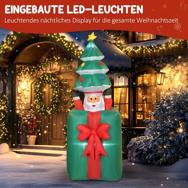 Aufblasbare Weihnachtsdekoration mit Weihnachtsmann in Geschenkkarton und Weihnachtsbaum auf dem Kopf, mit eingebauter LED-Beleuchtung vor einem Haus.
