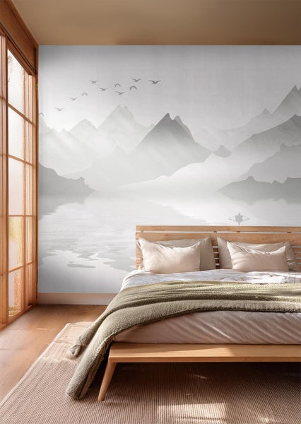 Schlafzimmer mit Fototapete Berglandschaft über dem Bett