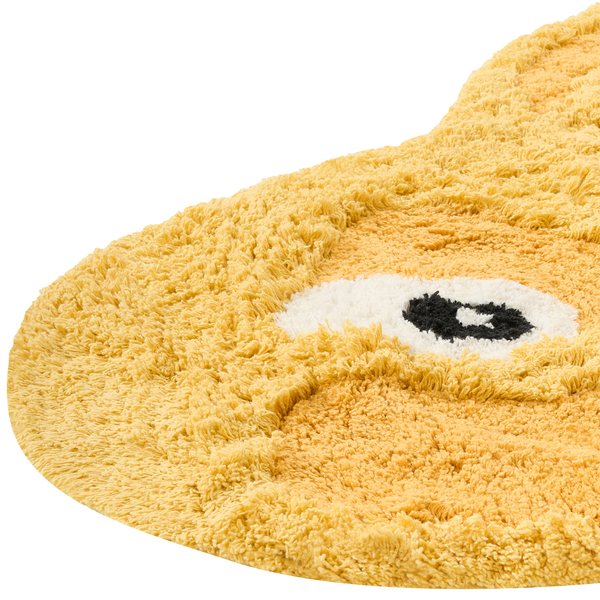 Flauschiger Badteppich in Tierform mit Strukturflor und Augenmotiv.