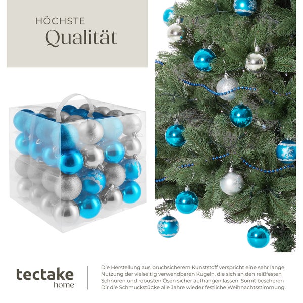 Weihnachtsbaumkugeln in silber und blau mit Muster in einer transparenten Box, mit einem dekorierten Weihnachtsbaum