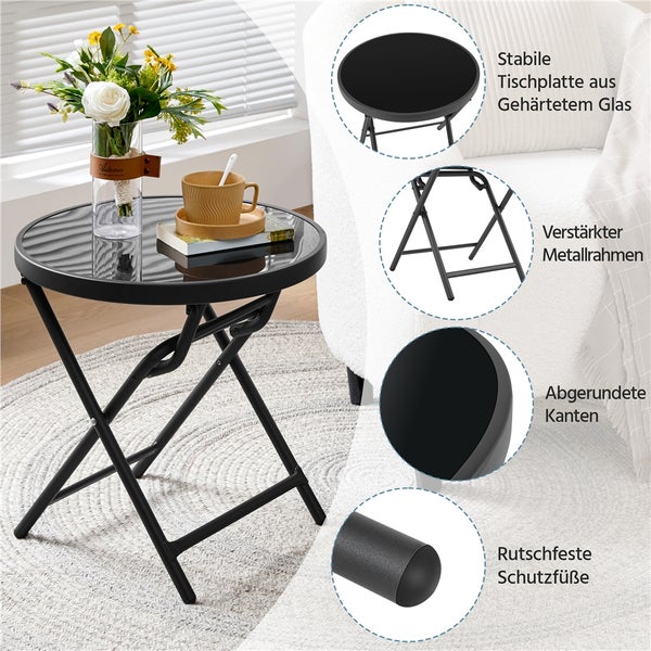 Schwarzer runder Klapp-Beistelltisch mit Tischplatte aus gehärtetem Glas, verstärktem Metallrahmen, abgerundeten Kanten und rutschfesten Standfüßen.