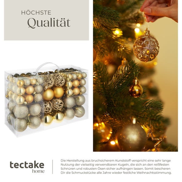 Weihnachtsbaumschmuck-Set in einer transparenten Kunststoffbox und eine Hand, die eine goldene Kugel an einen Weihnachtsbaum hängt