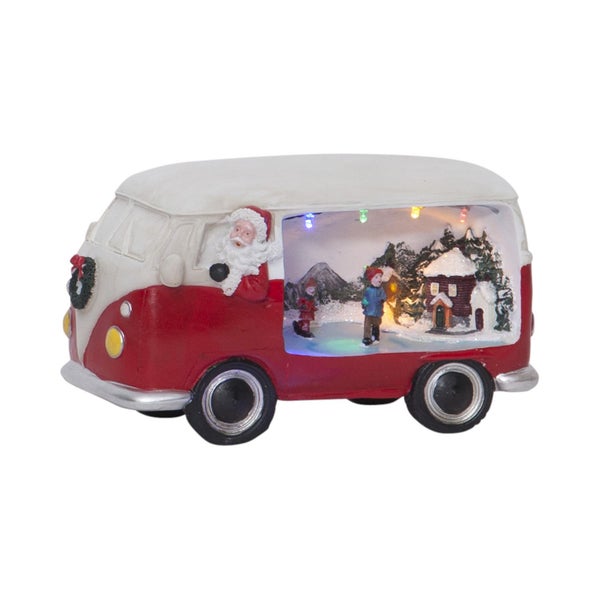 Dekorative Weihnachts-Szene in einem roten und weißen Bus mit Weihnachtsmann-Figur