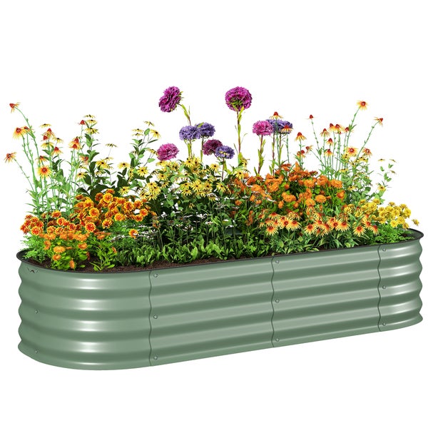 Grünes Hochbeet aus Wellblech mit gelben Blumen auf einer Rasenfläche vor einer hellen Hauswand mit Steinfundament.