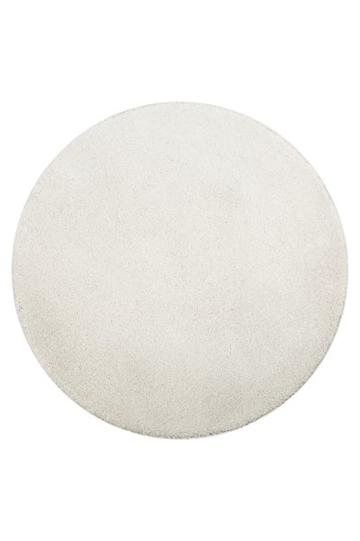 Runder, weißer Hochflor-Teppich mit weicher Oberfläche.