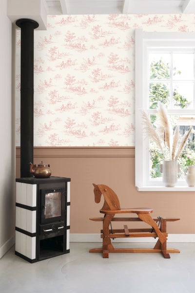 Raumgestaltung mit ländlicher Toile-de-Jouy-Tapete, brauner Wandfarbe, einem Kaminofen und einem Holzschaukelpferd.