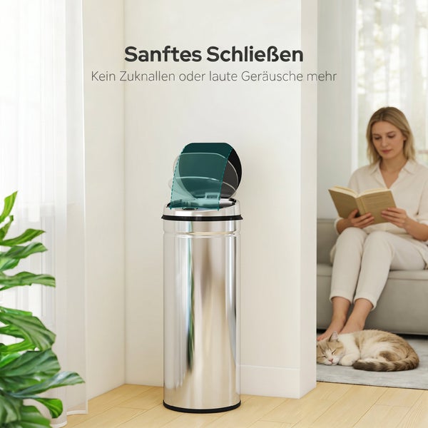Ein runder Treteimer aus Metall mit Softclose Deckel steht in einem Wohnzimmer neben einer Frau die liest und einer schlafenden Katze.