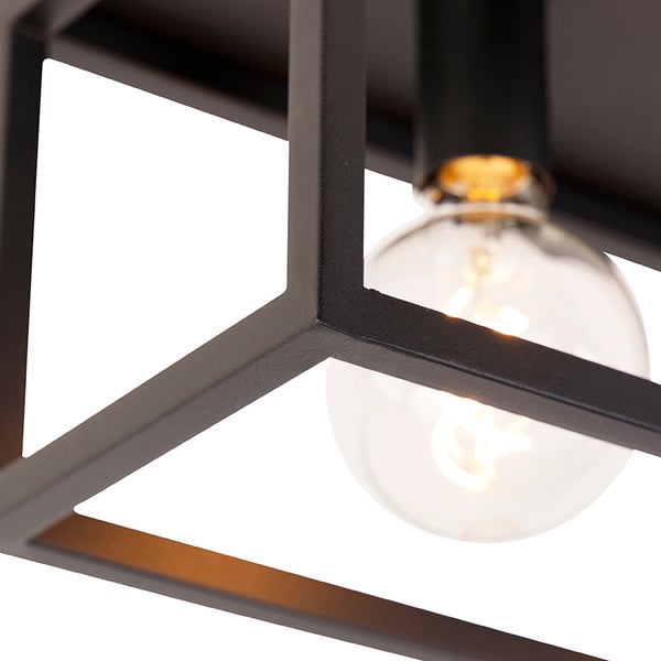 Detailaufnahme einer schwarzen Deckenleuchte mit geometrischem Design und einer Glühbirne