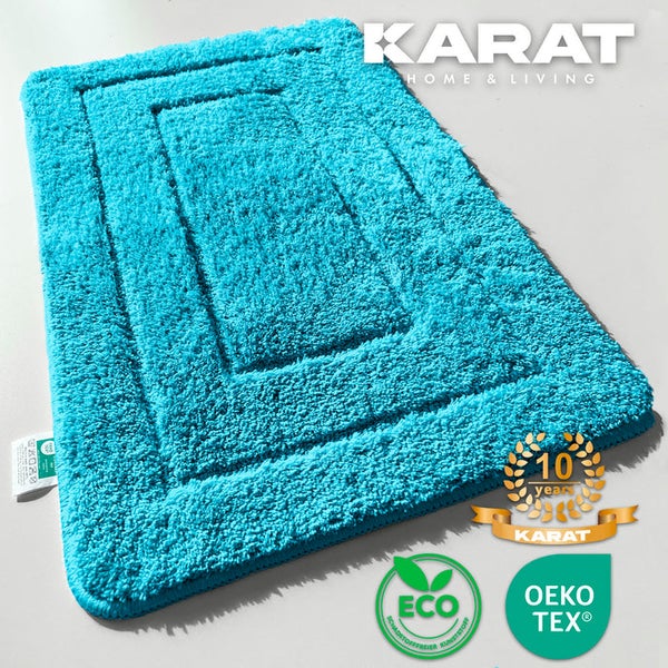 Türkisfarbene Badematte mit rechteckigem Muster und Zertifizierungssiegeln