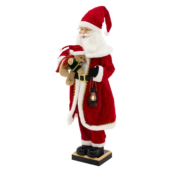 Dekorative Weihnachtsmannfigur mit Teddybär und Laterne auf Sockel