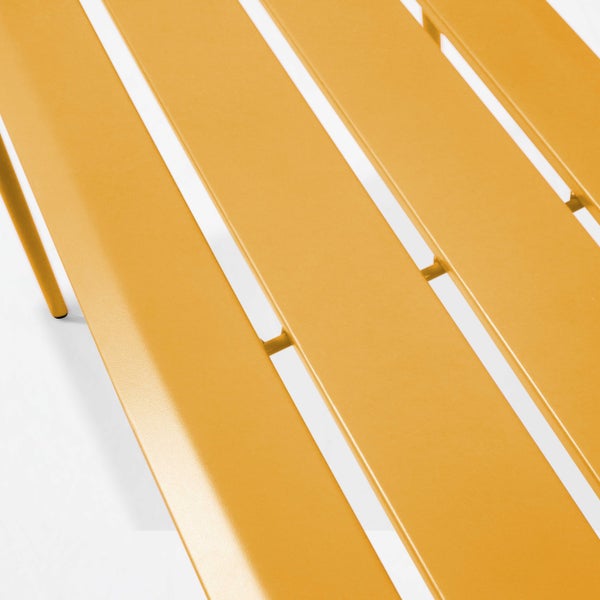 Detailansicht einer Tischoberfläche aus gelben Metalllamellen mit schmalen Zwischenräumen.