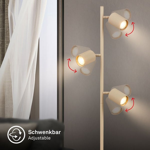 Dreiflammige Stehleuchte mit schwenkbaren zylindrischen Strahlern für eine flexible Beleuchtung im Wohnraum.