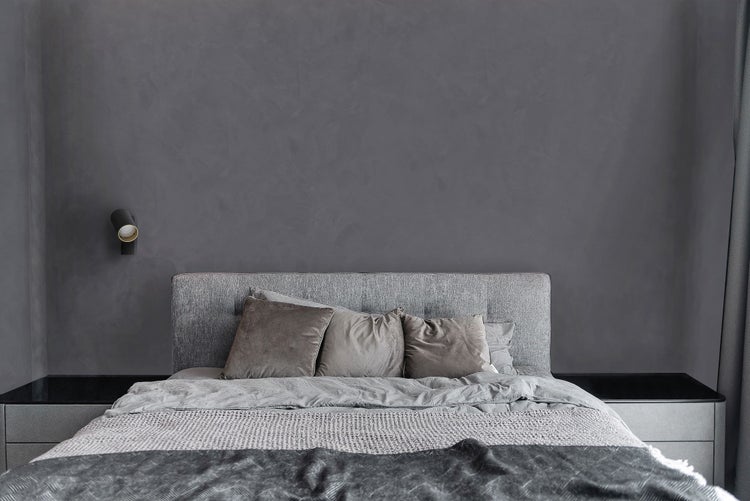 Schlafzimmer mit Bett, Nachttischen und Wandleuchte