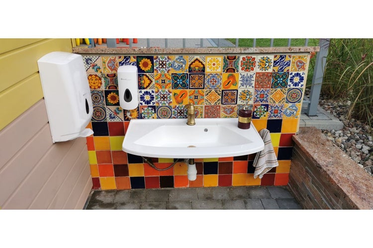 Außenwaschbecken mit Seifenspender und Handtuch