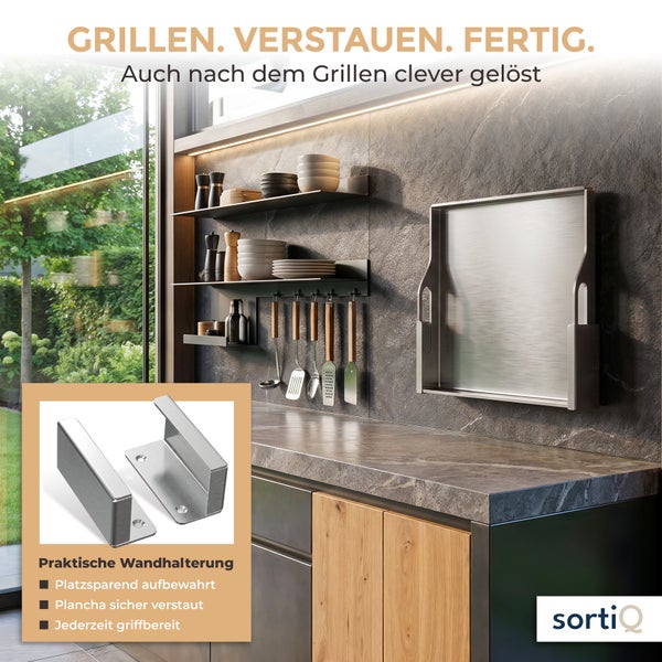 Wandhalterung aus Metall zur platzsparenden Aufbewahrung einer Plancha in einer modernen Außenküche mit Steinoptik