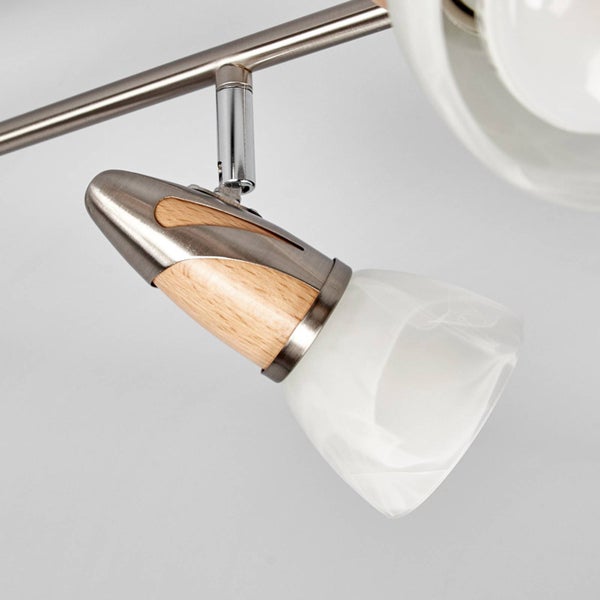 Verstellbarer Spot aus gebürstetem Metall mit hellen Holzelementen und einem weißen Lampenschirm aus mattiertem Glas.