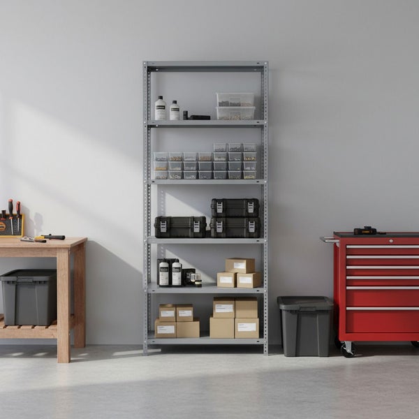 Organisierte Werkstatt mit einem grauen Metallregal, gefüllt mit Boxen und Behältern, neben einem roten Werkstattwagen und einer Werkbank.