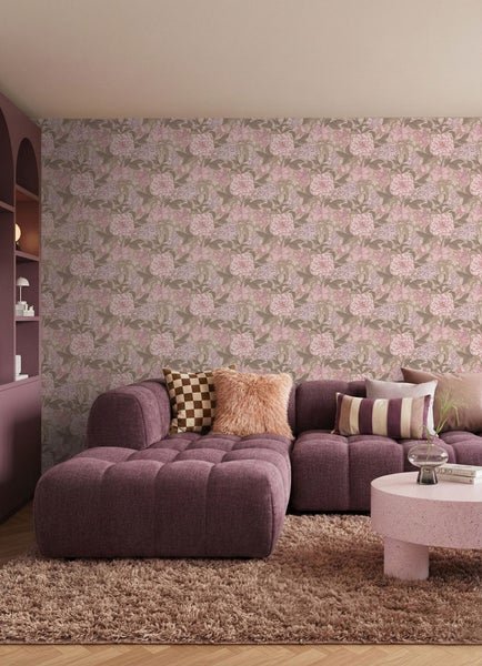 Wohnzimmer mit Couch, Kissen, Couchtisch, Regal und floraler Tapete für ein gemütliches Ambiente