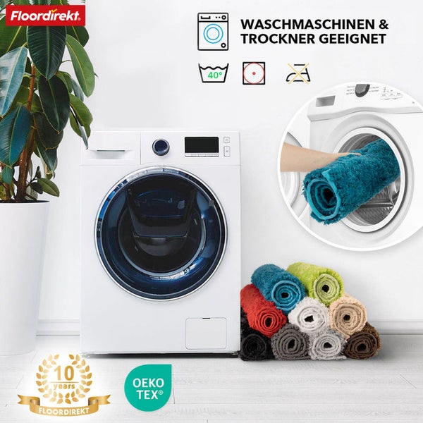 Waschmaschinengeeignete Badematten neben einer Waschmaschine und dem Floordirekt Logo