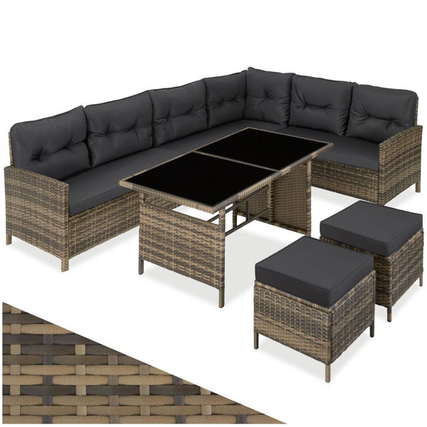 Polyrattan Garten-Lounge-Set bestehend aus Ecksofa, Tisch mit Glasplatte, zwei Hockern und anthrazitfarbenen Polstern.