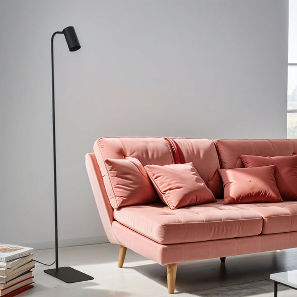 Rosa Sofa mit Kissen und Stehlampe in einem hellen Wohnzimmer